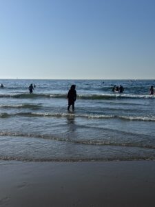 Shamna standing in the sea during a beach grounding moment after Vipassana